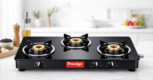 Prestige gas stove 3 burner ब्लैक ग्लास टॉप और ब्रास बर्नर के साथ